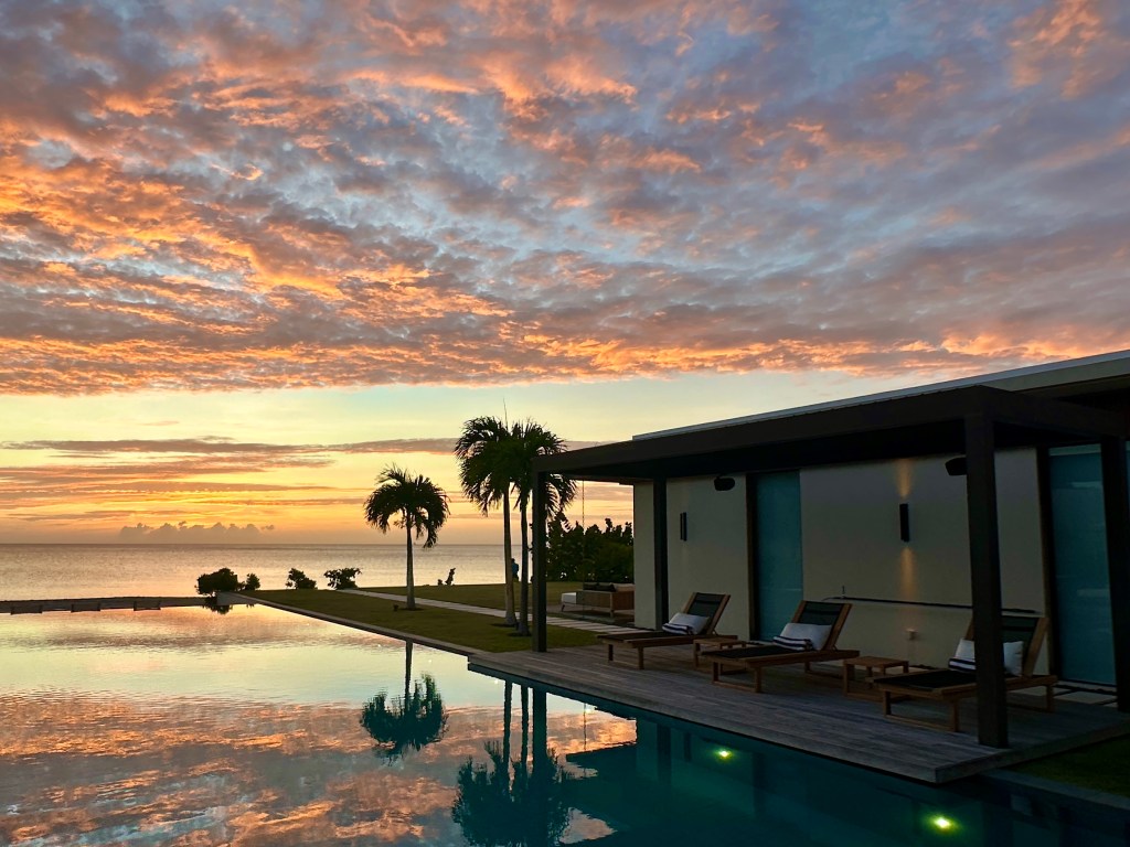 Sunset view over the pool of a private Four Bedroom Beach Villa at Silversands Grenada Grand Anse