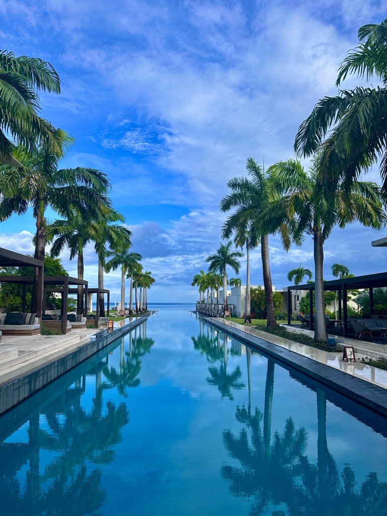 Infinite pool stretching from the entrance to the beach at Silversands Grenada Grand Anse Resort